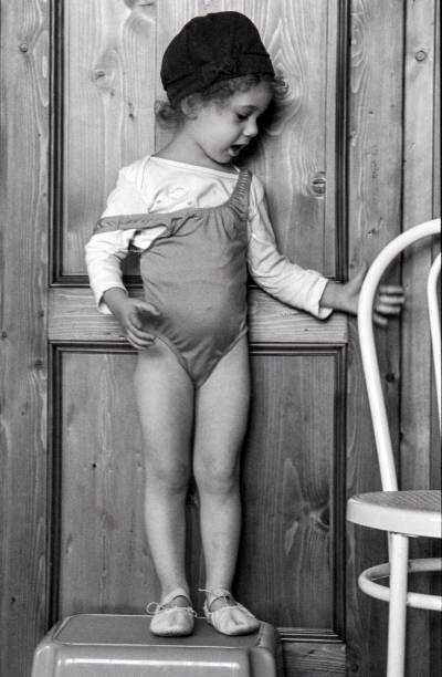 istock A little girl standing on a stool 1300763274