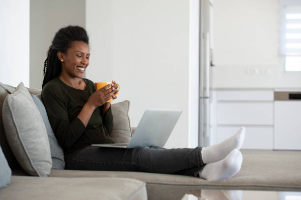 istock Working from home. Woman talking via video call online, drinking a hot drink. 1300764206