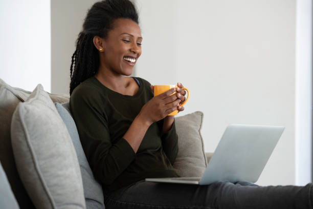 istock Working from home. Woman talking via video call online, drinking a hot drink. 1300764232