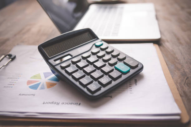 istock close-up calculator on graph documents, device for calculating the numbers 1300768868
