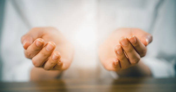 Woman hands praying (makes a dua) and light on palm. Woman hands praying (makes a dua) and light on palm. hands cupped stock pictures, royalty-free photos & images