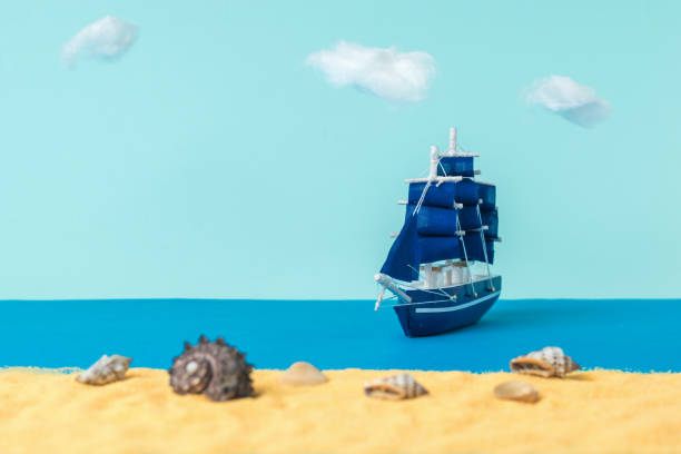istock Installation of a sailboat moored to a sandy beach with seashells. 1300770521