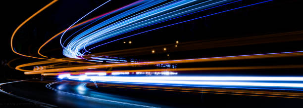 istock lights of moving cars at night. long exposure 1300772278