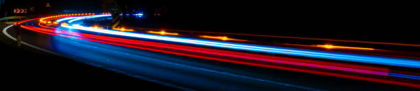istock lights of moving cars at night. long exposure 1300772282