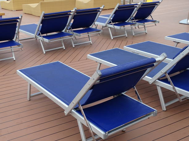 istock Cruise ship lying sunbeds in blue on an outside deck sun deck by the pool 1300773377