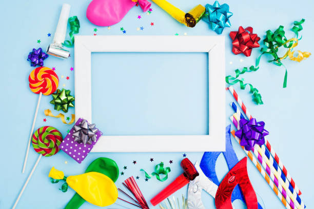 istock Birthday white frame with party accessories on blue background. Copy space 1300775215