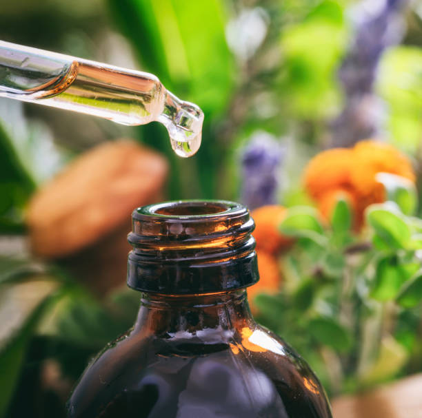 istock Variety of herbs and dropper on blur background. 1300780179