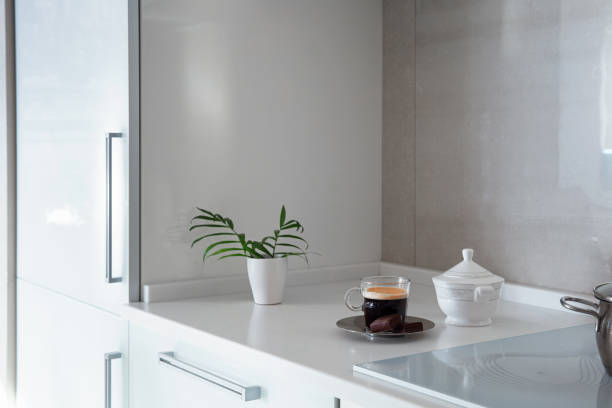 Cup of coffee on a stylish white kitchen table top. Mockup, template. Empty space for household appliances. Empty tabletop.
