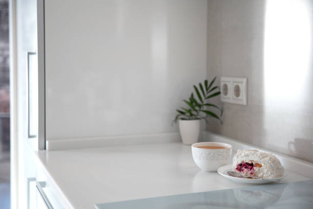 istock Cup of coffee on a stylish white kitchen table top. Mockup, template. Empty space for household appliances. Empty tabletop. 1300783075