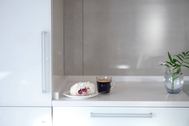 istock Cup of coffee on a stylish white kitchen table top. Mockup, template. Empty space for household appliances. Empty tabletop. 1300783719