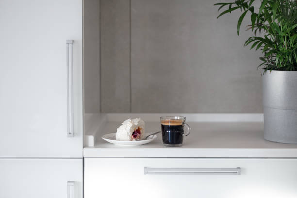 istock Cup of coffee on a stylish white kitchen table top. Mockup, template. Empty space for household appliances. Empty tabletop. 1300783928