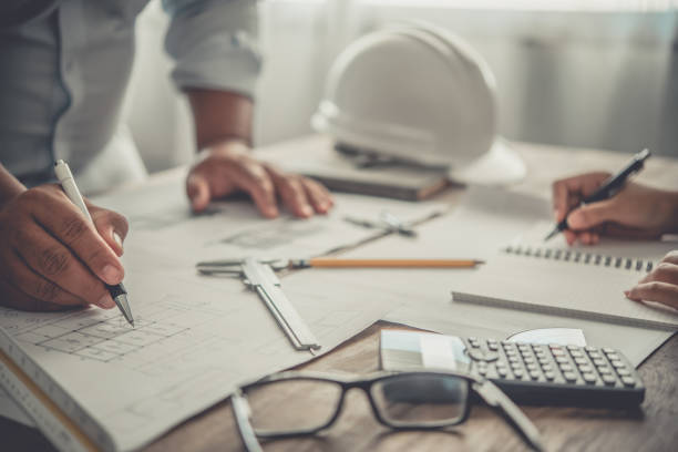 istock engineer working in office with blueprints, inspection in workplace for architectural plan, construction project ,Business construction 1300784451
