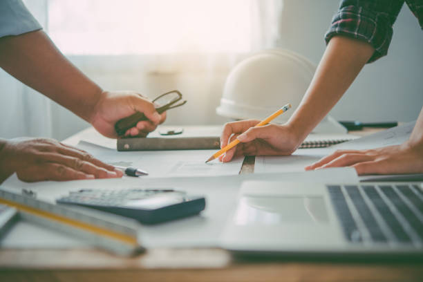 istock engineer working in office with blueprints, inspection in workplace for architectural plan, construction project ,Business construction 1300784454