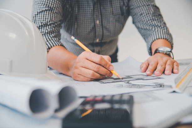 istock engineer working in office with blueprints, inspection in workplace for architectural plan, construction project ,Business construction 1300784468