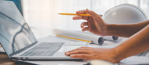 istock engineer working in office with blueprints, inspection in workplace for architectural plan, construction project ,Business construction 1300784475