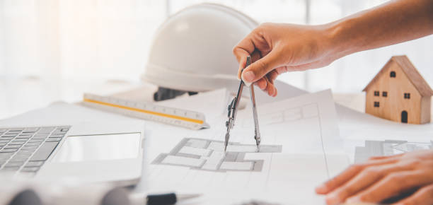 istock engineer working in office with blueprints, inspection in workplace for architectural plan, construction project ,Business construction 1300784480