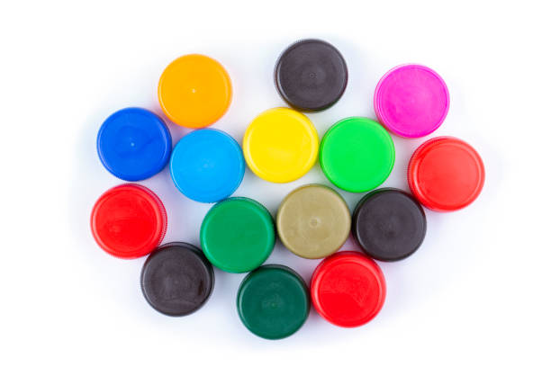 istock Group of multi colored bottle caps on a white background. Recycling and reuse concept. Space for text. 1300785774