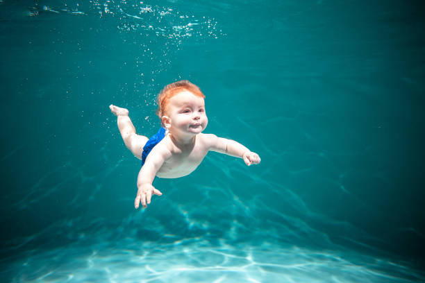 istock Cute Kid Dives in the Pool. Copy Space 1300786476
