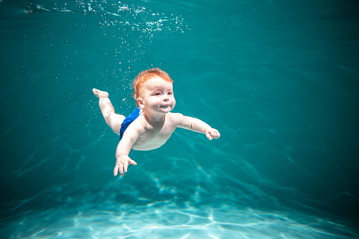 Baby Learns to Swim Underwater in the Pool