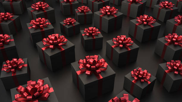 istock Black gift boxes with red ribbon, on black background, concept for holidays 1300786568