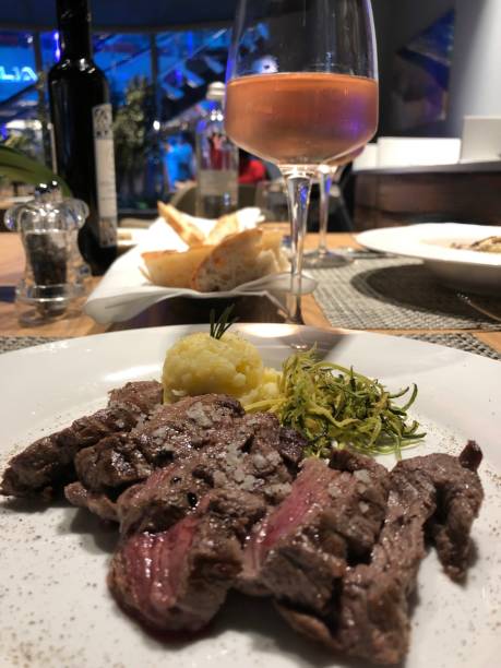 istock Close-Up of Dinner and Wine at Restaurant 1300787574