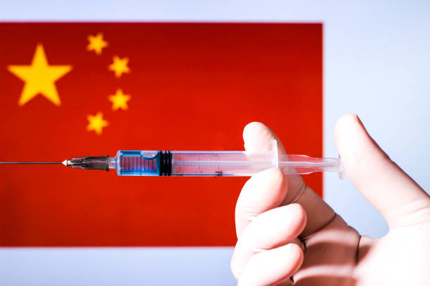 istock Hand holding syringe with covid vaccine 1300787590