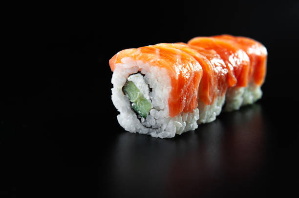 istock rolls of red fish on a black background isolate. Sushi on a black background 1300787644