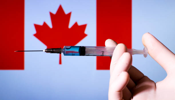 istock Hand holding syringe with covid vaccine 1300787659