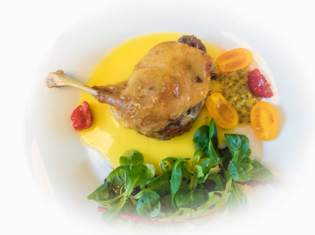 istock Duck leg confit with fruits sauce. Top view. 1300787700