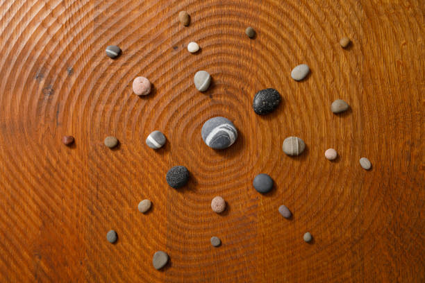 Pebbles arranged radially on a wooden floor