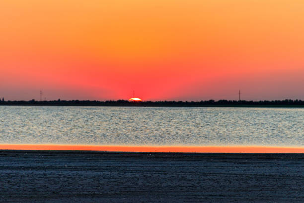 istock Beautiful orange sunset over a salt lake 1300788919