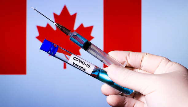 istock Hand holding syringe with covid vaccine 1300789354