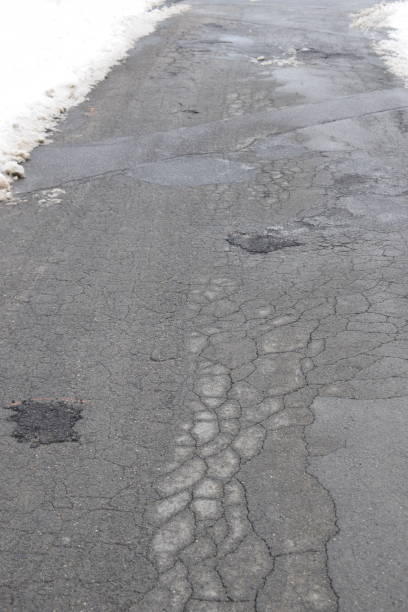 istock cracked road in winter 1300789965