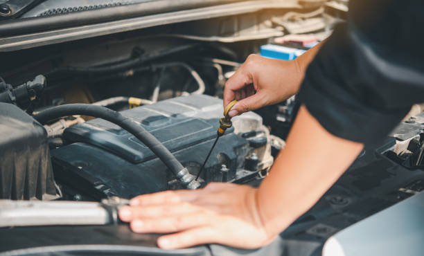 istock maintenance technician is doing a preliminary inspection of the engine to be ready to use. Concept of car maintenance 1300791452