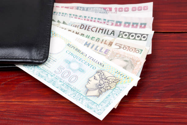 istock Old Italian money in the black wallet 1300792126
