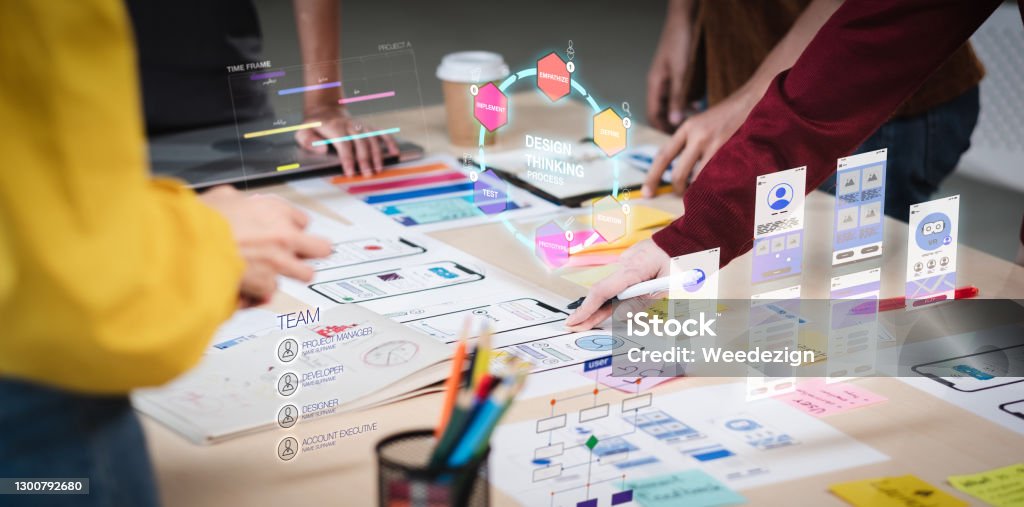 Close up ux developer and ui designer use augmented reality brainstorming about mobile app interface wireframe design on desk at modern office.Creative digital development agency User Experience Stock Photo