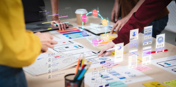 Close up ux developer and ui designer use augmented reality brainstorming about mobile app interface wireframe design on desk at modern office.Creative digital development agency stock photo