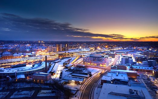 Odense city illuminated. Railway crossing through the image. Aerial drone shots