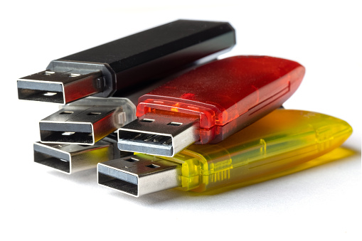 Pile of colorful USB Sticks on white background