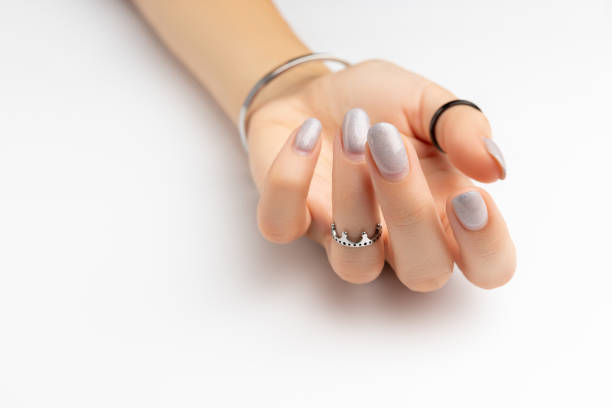 istock Womans hand with grown manicure on white background with copy space 1300794919