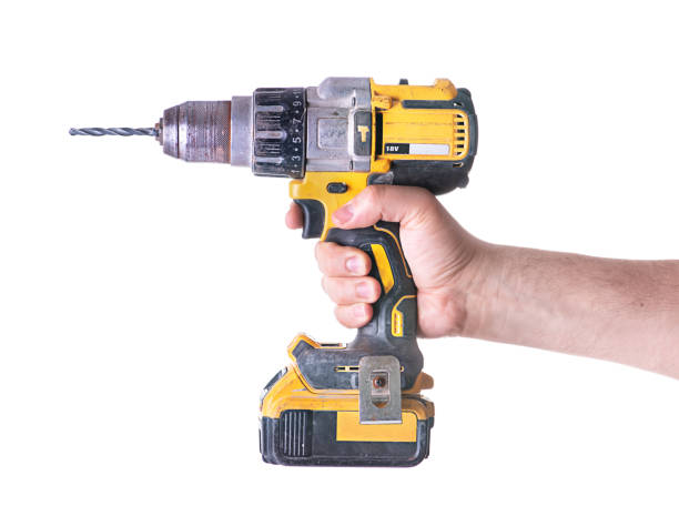 istock Yellow cordless battery powered drill isolated on white background. 1300795965