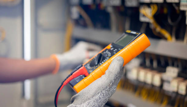 istock Electrician engineer uses a multimeter to test the electrical installation and power line current in an electrical system control cabinet. 1300797256