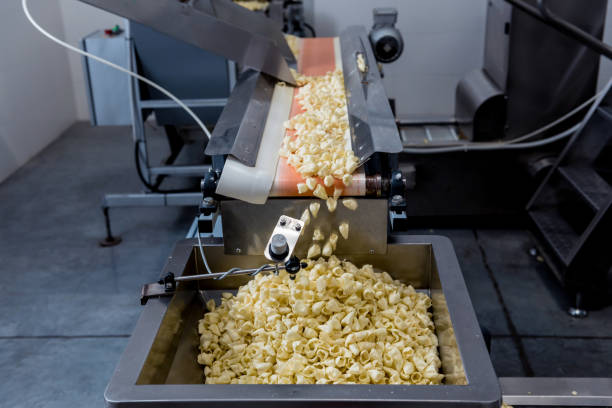 istock Conveyor line for packing snacks and chips in a modern factory 1300801327