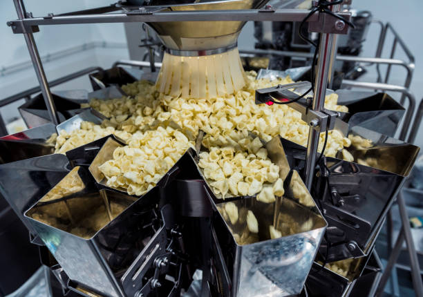 istock Vertical multi-head weigher packaging machine snacks and chips in a factory 1300803598