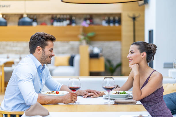 istock Couple sitting in restaurant and having lunch 1300804260