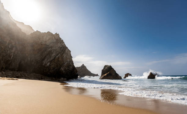 istock Sunset at isolated and beautiful beach, rock formation, praia da ursa 1300805908