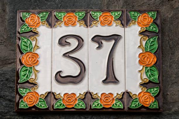 Number 37 of enamelled tiles Weathered grunge square faience enameled decorated plate of number of street address with number 37 closeup number 37 stock pictures, royalty-free photos & images