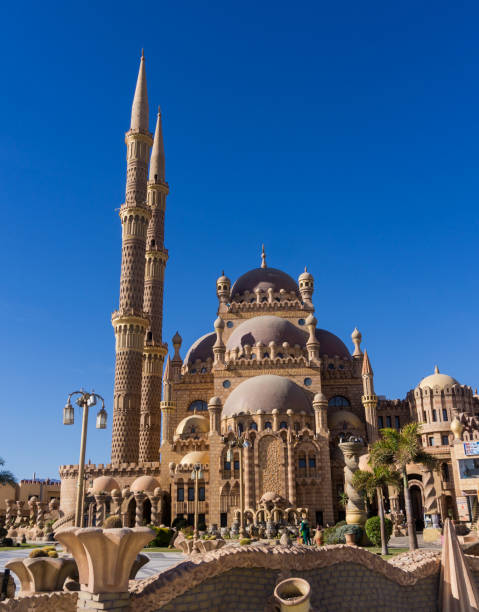 istock Beautiful large Islamic mosque at the sky background 1300806182