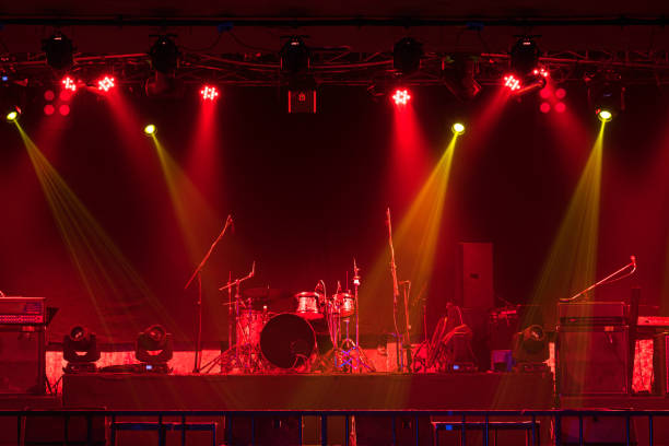 istock Musical instruments with spotlight on the stage with light ray  in conference hall or nightclub, party and celebrate, happy new year and merry Christmas concept, dump, guitar, microphone, 1300806280