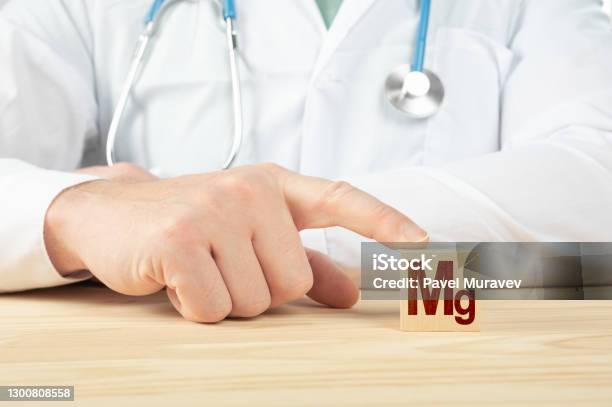 Chemical Element Mg Necessary For Human Health Essential Vitamins And Element For Humans Mg Alphabet On Wood Cube Doctor Recommends Taking Magnesium Doctor Talks About The Benefits Of Magnesium Stock Photo - Download Image Now